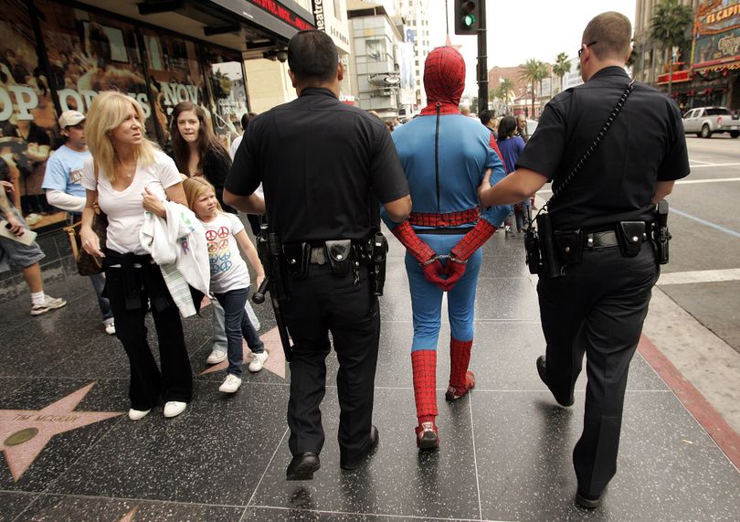 Los Angeles police officers arrest a man in a Spider-Man costume in Hollywood on Wednesday. Los Angeles Times (Los Angeles Times)