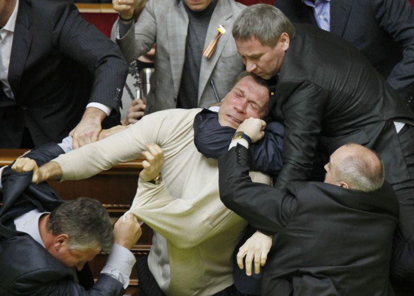 Ukrainian opposition and pro-presidential lawmakers fight during ratification of the Black Sea Fleet deal with Russia, in parliament in Kiev, Ukraine, Tuesday, April 27, 2010. Ukraine's parliament has voted to extend Russia's lease of a Crimean naval port for the Black Sea Fleet in a chaotic session during which eggs and smoke bombs were thrown. The countries' presidents agreed last week to extend the Russian navy's use of the Sevastopol port for another 25 years after the old lease expires in 2017. (Efrem Lukatsky / Associated Press)