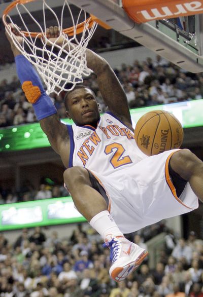 Nate Robinson of the New York Knicks dunks on the way to his third title.  (Associated Press)