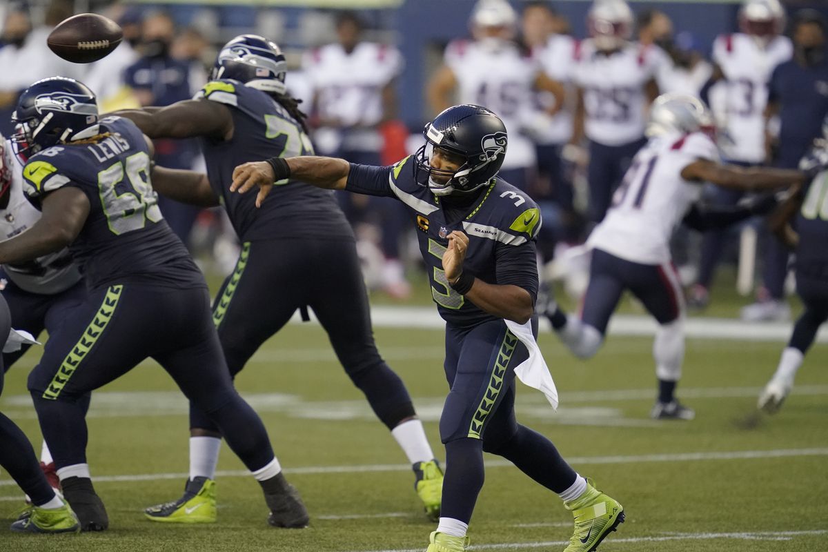 Seattle Seahawks quarterback Russell Wilson passes against the New England Patriots during the second half of an NFL football game, Sunday, Sept. 20, 2020, in Seattle.  (Elaine Thompson)