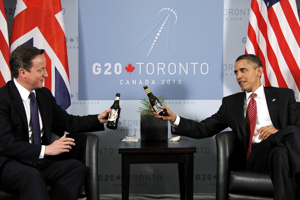 President Barack Obama and British Prime Minister David Cameron exchange beers during their bilateral meeting on the sidelines of the G-20 summit in Toronto on Saturday.  (Associated Press)