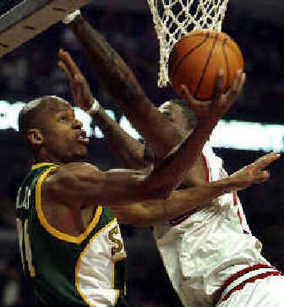 
Seattle's Ray Allen, left, avoids Chicago's Eddy Curry to score two points on Tuesday. 
 (Associated Press / The Spokesman-Review)