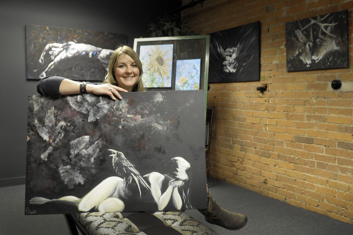 Christina Deubel creates a wide range of emotional images ranging from flowers to darker emotions. She is shown with examples of her artwork at the new Studio 66 gallery where she will be showing her work through January. She also will have works at Santé. (Christopher Anderson)