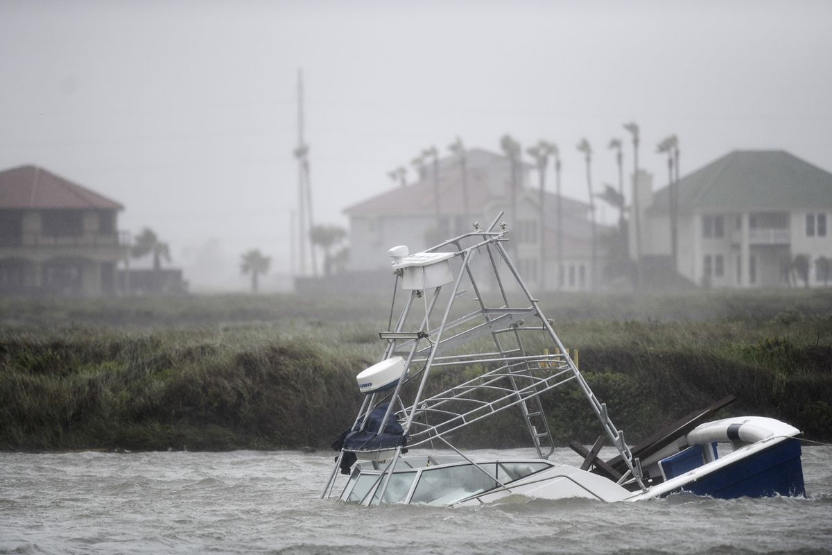 A boat sinks in the Packery Channel during Hurricane Hanna, Saturday, July 25, 2020, in North Padre Island, Texas. The Category 1 storm continued to strengthen before reaching Padre Island at 5 p.m. Saturday. (Annie Rice)