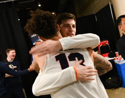 Baylor grad assistant Rem Bakamus (right) hugs former Gonzaga teammate Josh Perkins before the Zags routed Fairleigh Dickinson at the 2019 NCAA Tournament in Salt Lake City. The Zags defeated Baylor 83-71 two days later in the second round.   (Tyler Tjomsland/The Spokesman-Review)