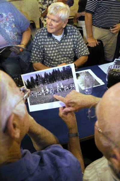 
Jim Upchurch, left, and Les Hogan view team photo while coach Sam Adams looks on Tuesday. 
 (Christopher Anderson / The Spokesman-Review)