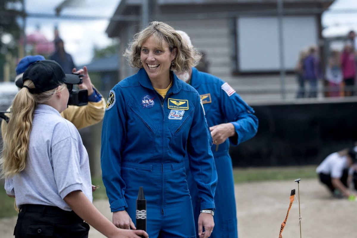 In this Thursday, May 19, 2016 photo, Astronaut Dorothy Metcalf-Lindenburger of Seattle, talks with Addisen Kingery before launching several rockets at Priest River Elementary School, Idaho. It was the 25th year of astronauts visiting the school for 5th grade teacher Chris Naccarato