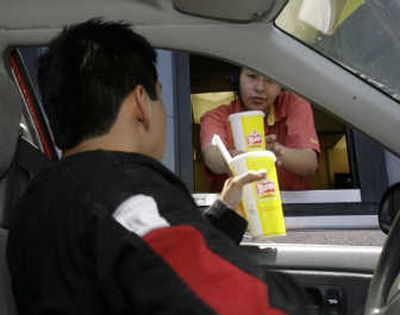 
Byron Lopez receives his order at a Wendy's restaurant Monday in Los Angeles. Associated Press
 (Associated Press / The Spokesman-Review)