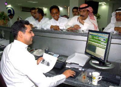 
A group of Saudi men wait to fill out forms for their stock accounts at a bank in the seaside city of Jiddah, Saudi Arabia. Saudi Arabia is in the midst of a stock market boom, with more than 2 million Saudis actively investing in the market. In 1999, the index stood at about 1,300. Today, it's 17,000. 
 (Associated Press / The Spokesman-Review)