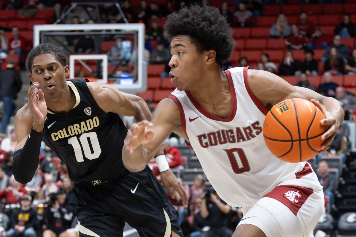 Washington State’s Jaylen Wells drives around Colorado’s Cody Williams in the first half of Saturday’s Pac-12 game in Pullman.  (Geoff Crimmins/For The Spokesman-Review)