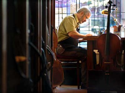 
James Kytonen, an instrument restorer, sits at the workbench in his Garland district shop, Violin Works. 
 (INGRID BARRENTINE / The Spokesman-Review)