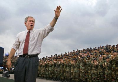 
President Bush waves and returns the welcoming shout of 