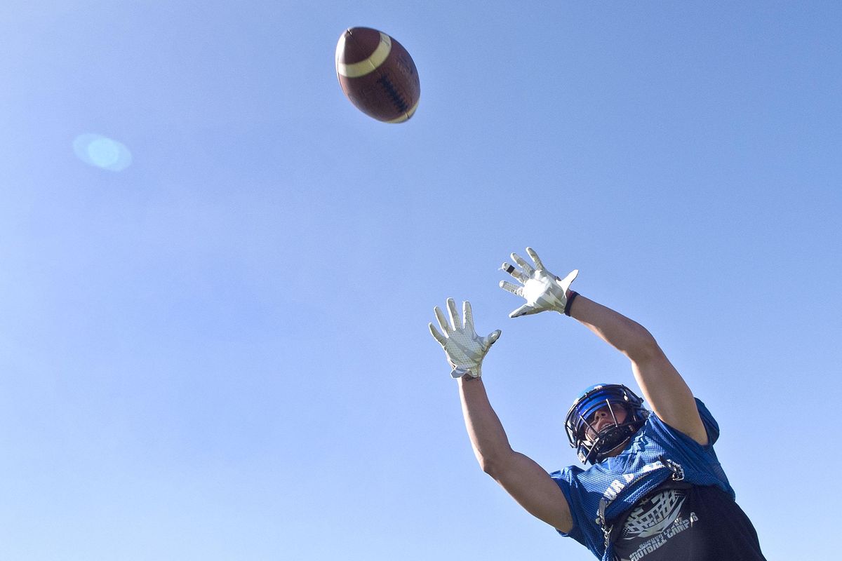 Wide receiver Colbey Nosworthy of Coeur d’Alene High School jumps for the ball during practice at the school on Tuesday, Aug. 27, 2019. (Kathy Plonka / The Spokesman-Review)
