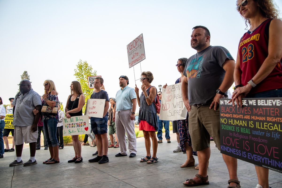 Spokane Valley residents, many holding signs denouncing white supremacy and bigotry, attend a rally at Spokane Valley City Hall on Aug. 14, 2018. The rally was held in response to some of Spokane