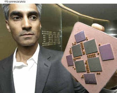 IBM chief scientist Ravi Arimilli holds a POWER 5 microprocessor module Monday in New York.
(Associated Press / The Spokesman-Review)