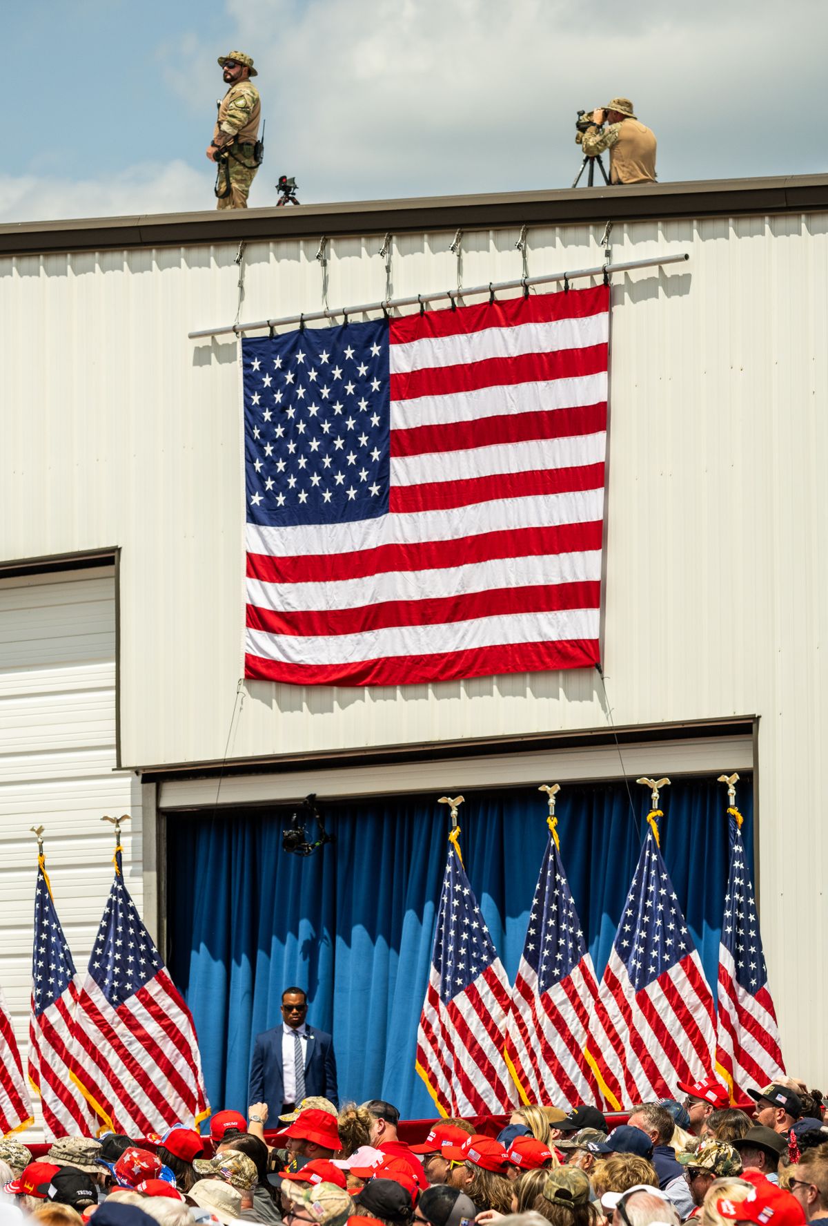 Security keeps watch as Donald Trump addresses a crowd in Asheboro, N.C., on Wednesday.   (Kate Medley/For The Washington Post)