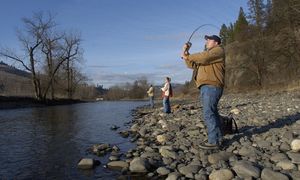 Dave McBride, right, Brandi Harbaugh, center, both of Jerome, Idaho, and Howard Cox, of Wendell, Idaho, take advantage of the spring-like weather Tuesday as they fish on the South Fork of the Clearwater River near Kooskia, Idaho. (Associated Press / The Spokesman-Review)