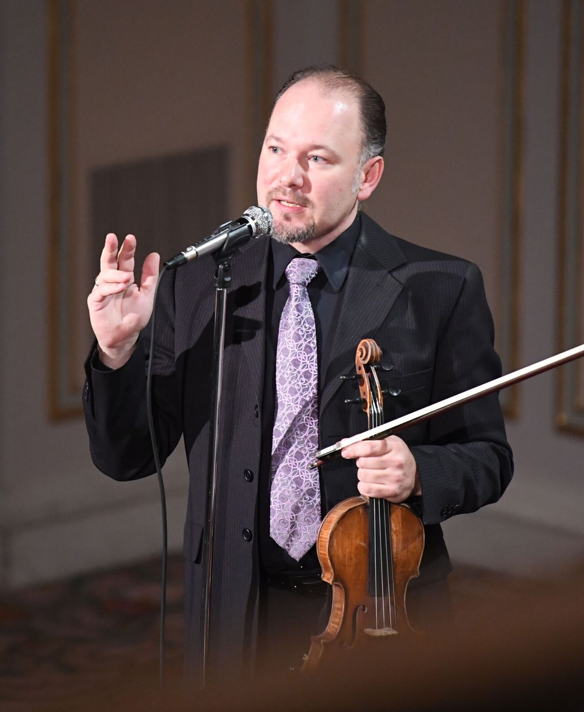 Mateusz Wolski, concertmaster of the Spokane Symphony, talks about the Prokofiev String Quartet No. 1 before joining a quartet to play it on Sept. 26, 2017, at the Davenport Hotel. While he can’t perform with the symphony, Wolski is still teaching lessons.  (Jesse Tinsley/The Spokesman-Review)