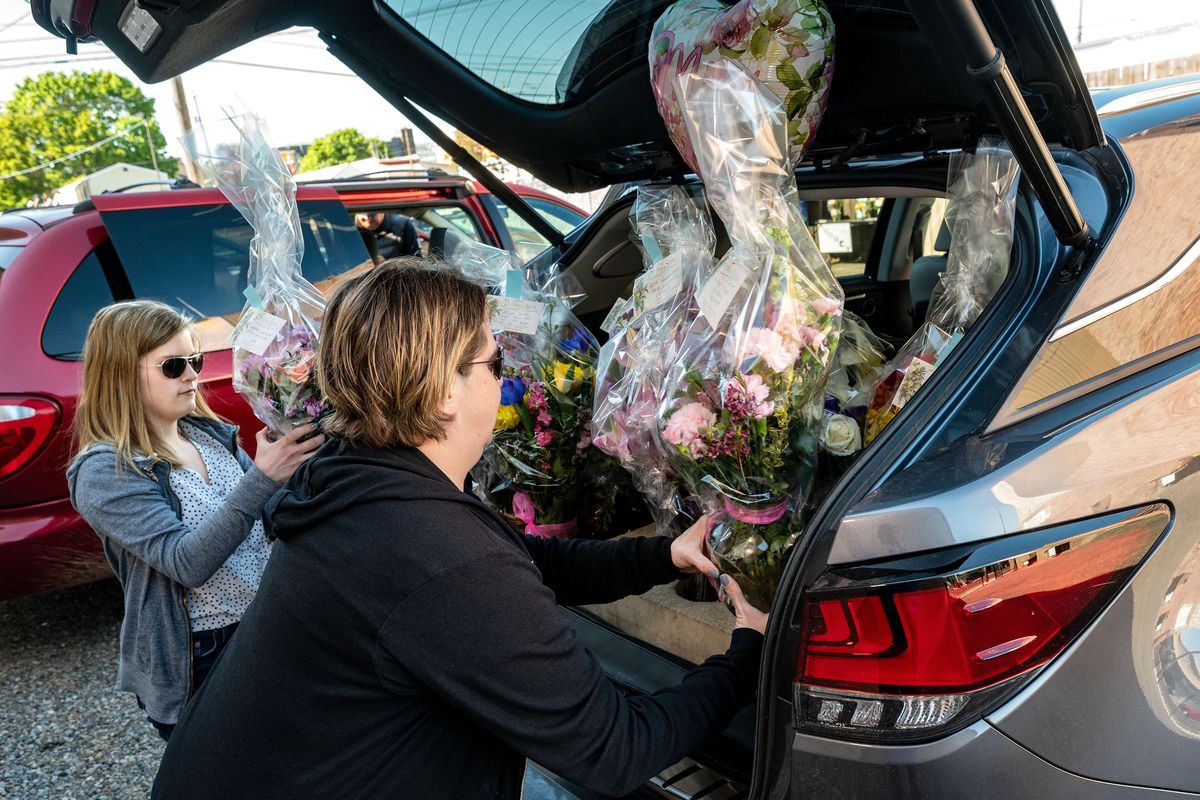 Peters and Sons Flowers & Gift delivery driver Karene Loman and her daughter Kenzie load up their vehicle with Mother’s Day flower arrangements, Friday, May 8, 2020. The floral business made about 150 deliveries Friday, about double from what they did last year. (Colin Mulvany / The Spokesman-Review)