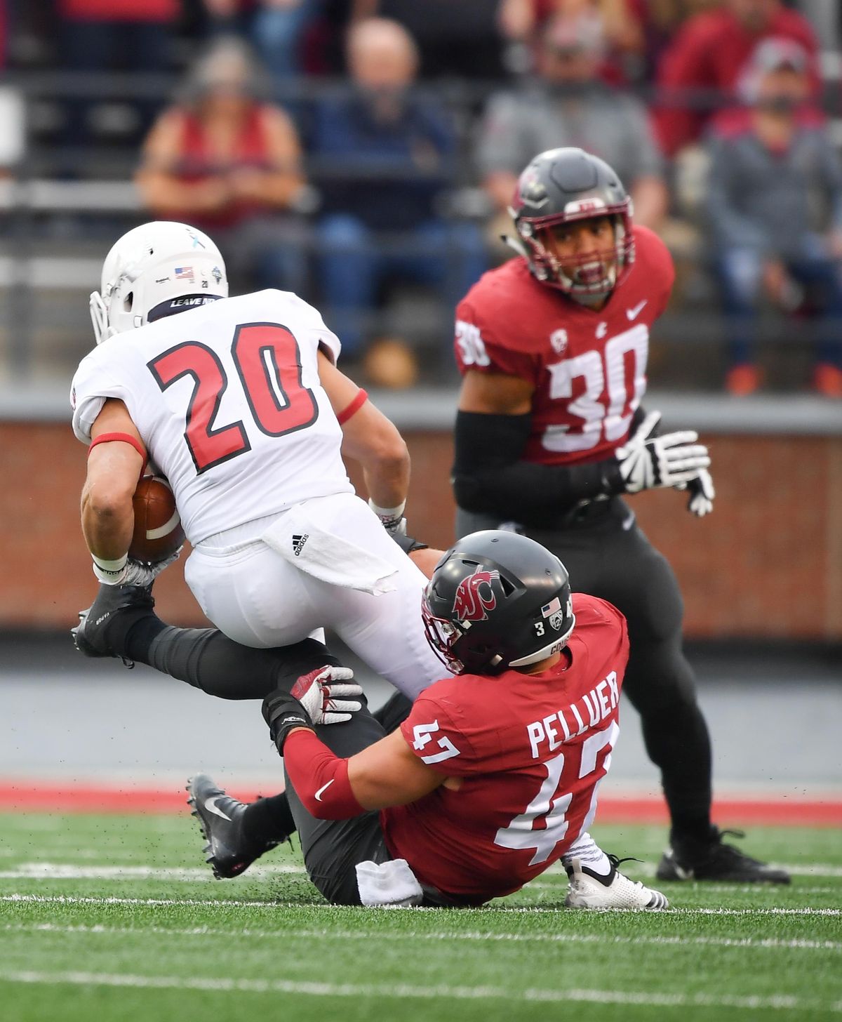 Washington State Cougars linebacker Peyton Pelluer (47) brings down Eastern Washington Eagles running back Sam McPherson (20) during the first half of a college football game on Saturday, September 15, 2018, at Martin Stadium in Pullman, Wash. (Tyler Tjomsland / The Spokesman-Review)