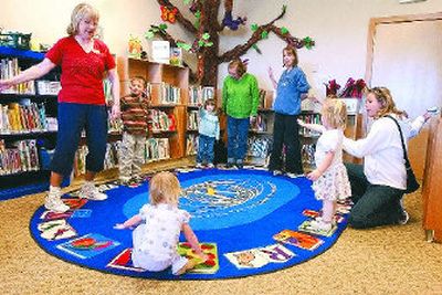 
Liberty Lake Municipal Library Clerk Diane Moll leads a group of children in the 