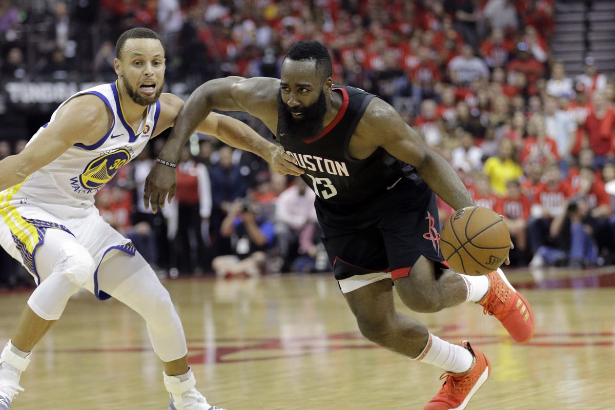 Houston Rockets guard James Harden (13) drives around Golden State Warriors guard Stephen Curry (30) during the second half of Game 1 of the NBA basketball Western Conference Finals, Monday, May 14, 2018, in Houston. (David J.Phillip / Associated Press)