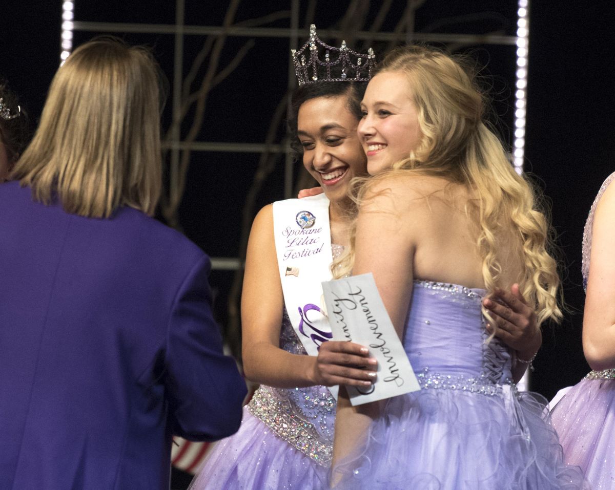 2017 Lilac Queen, August Corppetts, center, hugs 2016 Queen Megan Paternoster, right, after being named the queen of the Lilac Festivals Royal Court Sunday, Jan. 29, 2017. Corppetts is from Gonzaga Prep. (Jesse Tinsley / The Spokesman-Review)