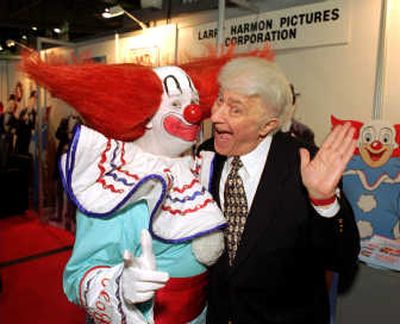Larry Harmon, who appeared as Bozo the Clown for decades and licensed the name to other Bozos around the world, poses with a man wearing the distinctive outfit in this January 1996 photo. Associated Press
 (File Associated Press / The Spokesman-Review)