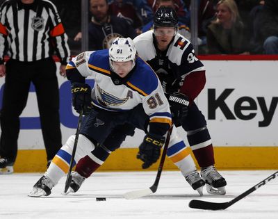 St. Louis Blues right wing Vladimir Tarasenko, front, collects the puck as Colorado Avalanche left wing Gabriel Landeskog defends in the third period of an NHL hockey game Saturday, Feb. 16, 2019, in Denver. The Blues won 3-0. (David Zalubowski / Associated Press)