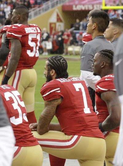 San Francisco 49ers quarterback Colin Kaepernick kneels during the national anthem before an NFL football game against the New England Patriots in Santa Clara, California on Sunday. (Ben Margot / Associated Press)