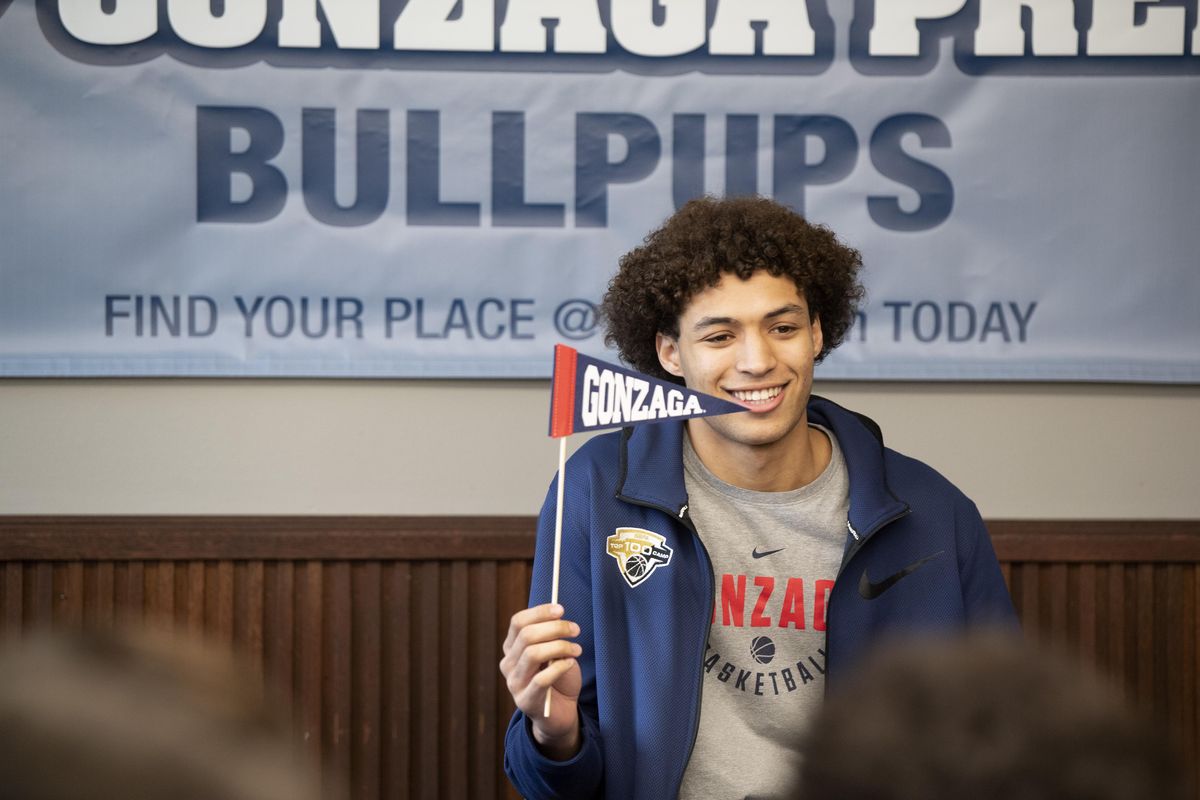 Gonzaga Prep basketball player Anton Watson waves a tiny pennant at his crowd of friends on Nov. 14 at G-Prep right before signing his letter of intent to attend Gonzaga University. (Jesse Tinsley / The Spokesman-Review)