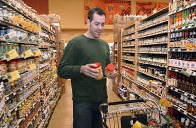 
Jeffrey Berman, 24, shops at a Whole Foods Market in Los Angeles. Berman tries to save money by going to the market instead of going out to eat and is in better financial shape than many of his peers. Experts say saving money needs to be a bigger priority for young adults. 
 (Associated Press / The Spokesman-Review)