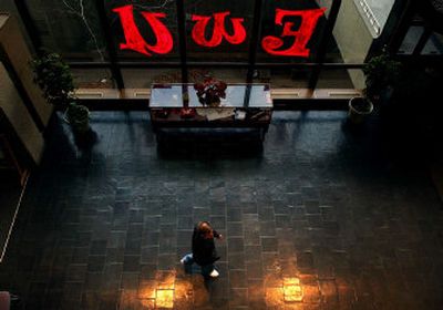 
A student walks through the Eastern Washington University building at Wall Street and First Avenue in downtown Spokane on Monday. 
 (Jed Conklin / The Spokesman-Review)