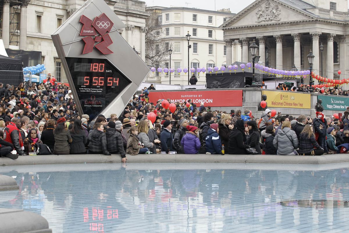 People gather around the Olympic countdown clock at Trafalgar Square in London to watch the Chinese New Year celebration. Trafalgar Square will host a giant video screen free to the public, showing events from the London 2012 Olympics. (Associated Press)