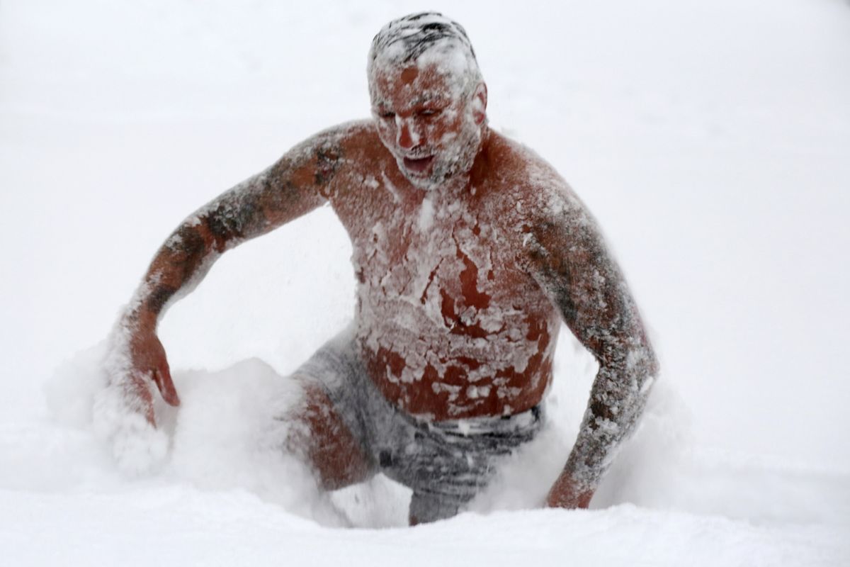 Enrico Ulbrich from Wernigerode bravely takes a dip in the fine powder snow in Wernigerode, Germany, Tuesday, Feb.9, 2021. The 41-year-old did not want to miss this fun with the huge amounts of snow in Wernigerode and romps around in the snow dressed only in a bathing suit.  (Matthias Bein)