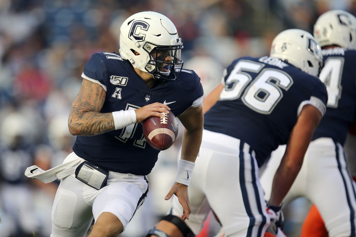 FILE - In this Sept. 7, 2019, file photo, Connecticut quarterback Jack Zergiotis (11) rolls out of the pocket during an NCAA football game against Illinois in East Hartford, Conn. UConn has canceled its 2020-2021 football season, becoming the first FBS program to suspend football because of the coronavirus pandemic. (Stew Milne)