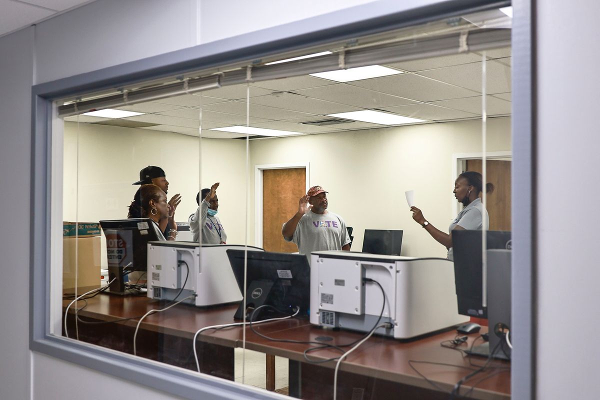 Election technician Brianna Garrett, (right) reads The Oath of Deputy Custodians to election officials inside the server room at Clayton County Board of Elections on Wednesday, September 14, 2022.    (Natrice Miller/The Atlanta Journal-Constitution/TNS)