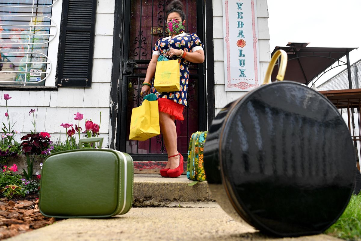 Summer Hightower, owner of Veda Lux poses for a photo on Monday, May 18, 2020, in Spokane. Hightower calls uses the vintage bags to make fashion deliveries to customers