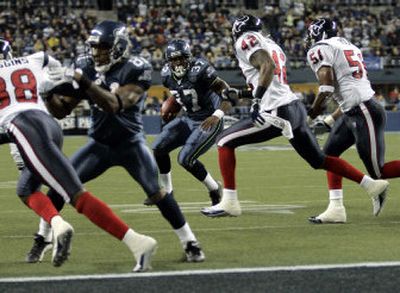 
Shaun Alexander has carried the ball into the end zone for a league-leading 12 touchdowns this season, but is only one reason for the Seahawks' success on offense.  
 (Associated Press / The Spokesman-Review)