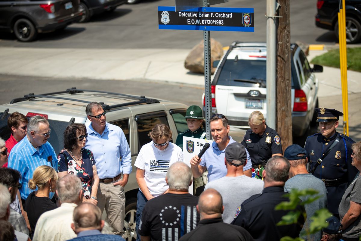 B. Keith Orchard, the only son of the late SPD detective Brian F. Orchard, speaks during a sign dedication ceremony on Tuesday, July 20, 2021. Orchard was killed in the line of duty 38 years ago Tuesday, and the sign that bears his name was erected at the location of the shooting at Fifth Avenue and Pine in Spokane, with family andn law enforcement officers in attendance.  (Libby Kamrowski/The Spokesman-Review)