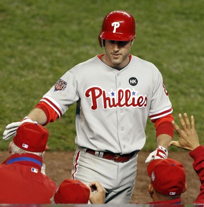 Chase Utley is congratulated after  hitting second of his two home runs in Game 1. (Kathy Willens / The Spokesman-Review)