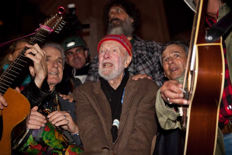 Activist musician Pete Seeger, 92, center, sings before a crowd of nearly a thousand demonstrators sympathetic to the Occupy Wall Street protests at a brief acoustic concert in Columbus Circle, Saturday, Oct. 22, 2011, in New York. The demonstrators marched down Broadway singing 