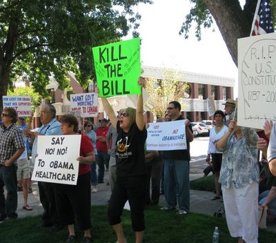 Counter-protesters shout from the back during a health care reform rally in Boise on Wednesday. (Betsy Russell / The Spokesman-Review)