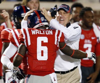Mississippi coach Hugh Freeze celebrates with Jaylen Walton after Walton's 91-yard touchdown run. (Associated Press)