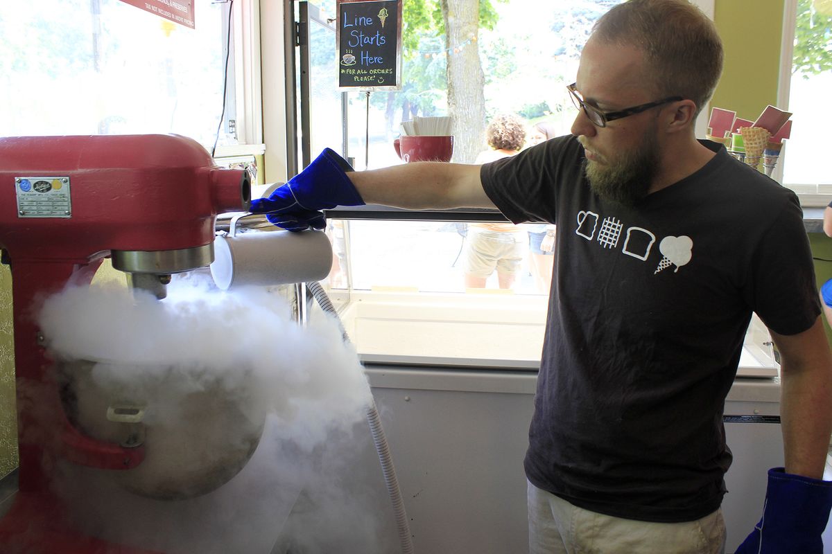 Michael Glaze pours liquid nitrogen into a batch of ice cream at The Scoop on Spokane’s South Hill. The corner ice creamery has been experimenting with the super-cool chemical element since early June. (Adriana Janovich)