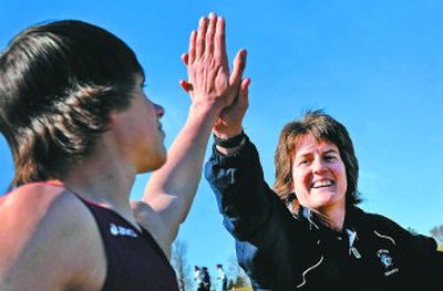
Mt. Spokane assistant track coach Jeanne Helfer gives javelin thrower Jared Ryan, 17, a high-five after a throw at Shadle Park High School in March.
 (Jed Conklin / The Spokesman-Review)