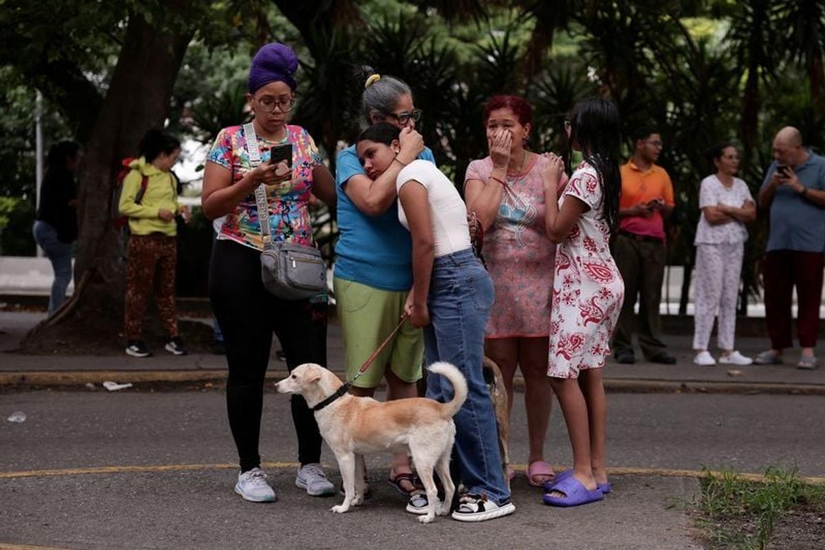People react as they gather after an earthquake Wednesday in Caracas, Venezuela.  (Gaby Oraa/Reuters)