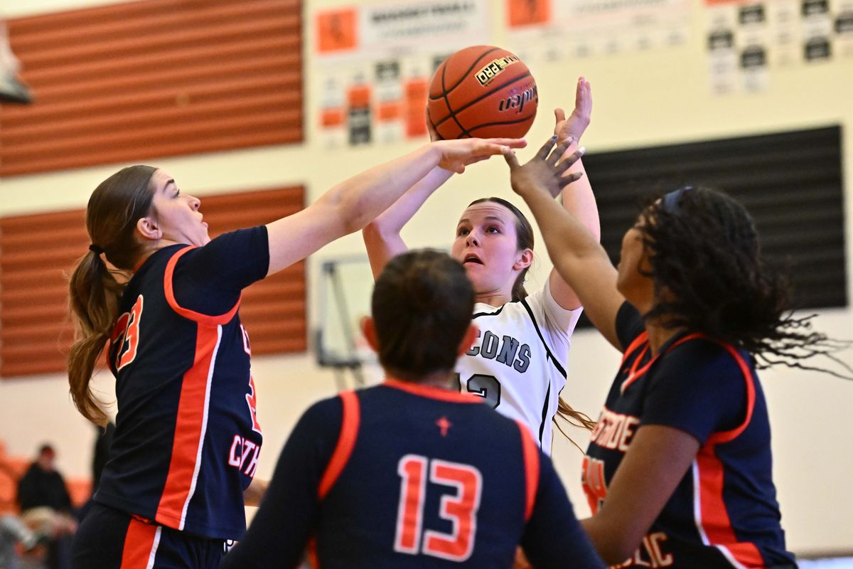 Ridgeline’s Grace Sheridan shoots against a swarm of Eastside Catholic defenders on Saturday at West Valley High School.  (James Snook/For The Spokesman-Review)