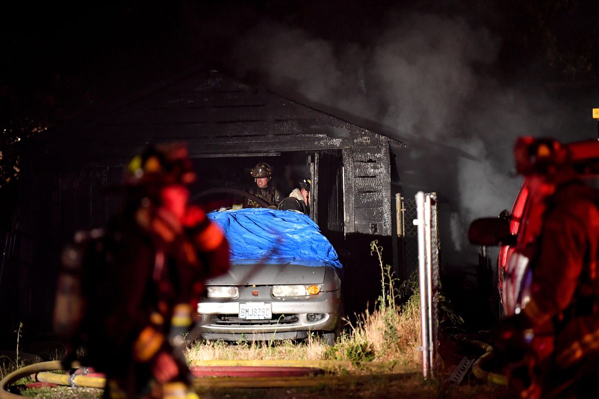 Fire crews mop up a structure fire on Tuesday, July 23, 2019, at Gordon and Division in Spokane, Wash. (Tyler Tjomsland / The Spokesman-Review)