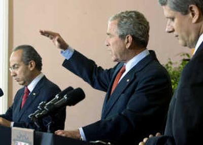 
President Bush, accompanied by Mexican President Felipe Calderon, left, and Canadian Prime Minister Stephen Harper, speaks Tuesday at a news conference about NAFTA. Associated Press
 (Associated Press / The Spokesman-Review)
